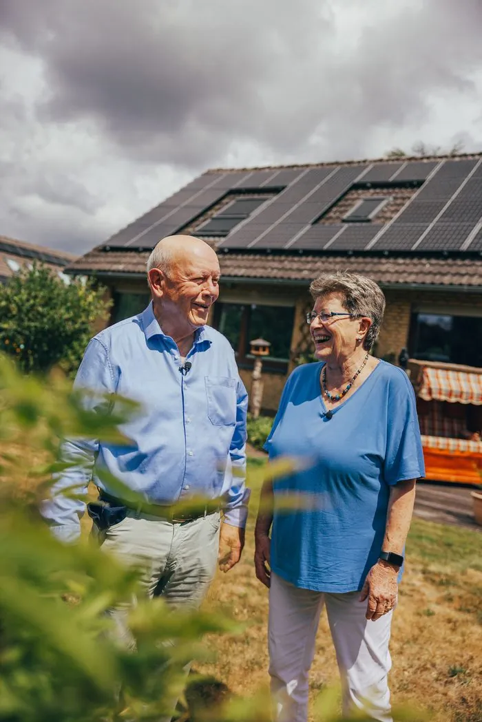 Zufriedenes enercity Kundenpaar vor dem eigenen Haus mit Solaranlage